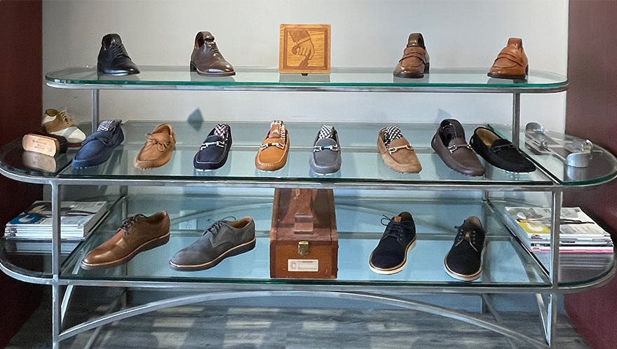 Shelf display of diverse range of footwear, including sneakers, boots, heels, and more, in various styles and colors to suit every taste.